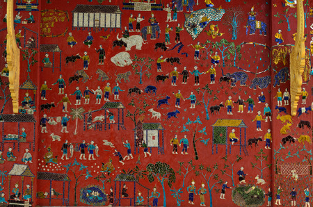 mosaic on pink wall of Wat Xieng Thong buddhist temple in Luang Prabang Laoの写真素材