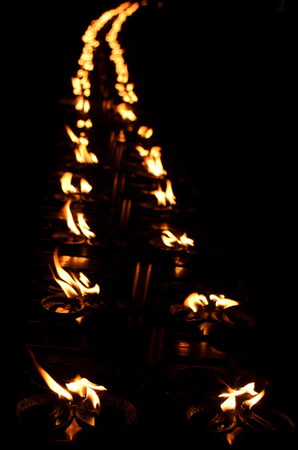 line of candles at Shwedagon pagodaの写真素材