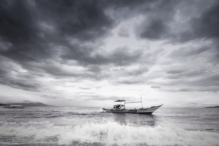 Fishing boat arriving at the shore.の素材