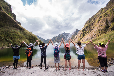 Friends celebrating the beautiful scenery of Mt. Pinatubo crater lake. Circa 2016のeditorial素材