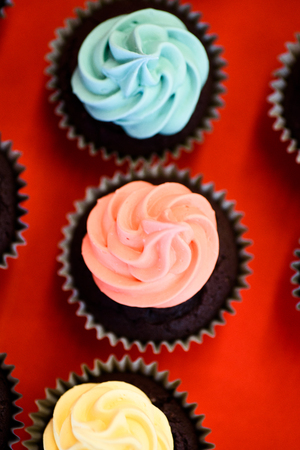Mouth watering cupcakes with colorful icing.の写真素材
