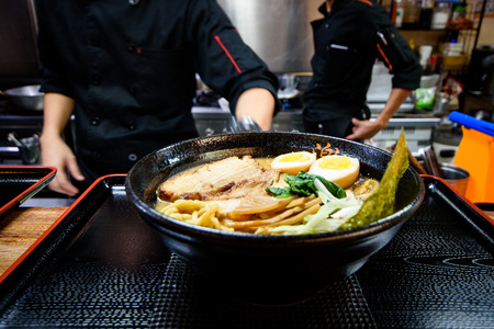 Cook geeting ready the Ramen for serving.の写真素材