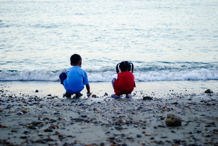 Kids playing at the shore.