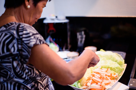 Preparing salad at the kitchen.の写真素材