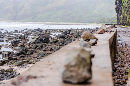 Stones lining at the side of the road.