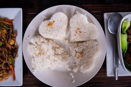 Heart shaped garlic rice served on the table.の写真素材