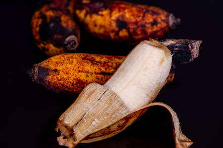Ripe banana full of potassium in black background.の写真素材