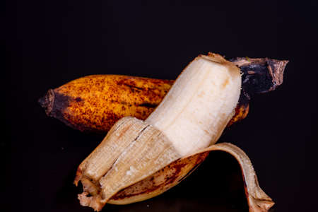 Ripe banana full of potassium in black background.の写真素材