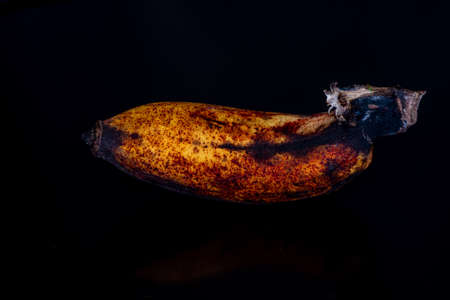 Ripe banana full of potassium in black background.の写真素材