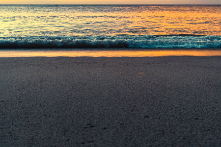 Beautiful reflection of golden color of sunset on the water at he beach.の写真素材