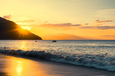 Enjoying summer at the beach of Puerto Galera, Philippines at sunset.の写真素材