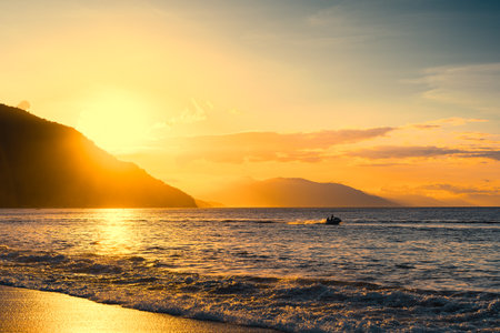 Enjoying summer at the beach of Puerto Galera, Philippines at sunset.の写真素材