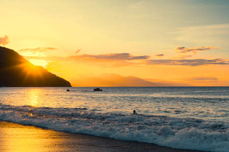 Enjoying summer at the beach of Puerto Galera, Philippines at sunset.の写真素材