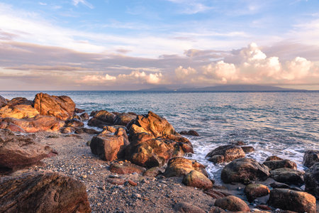 Scenic rock formation during sunrise at the beach of Mindoro, Philippines.の写真素材