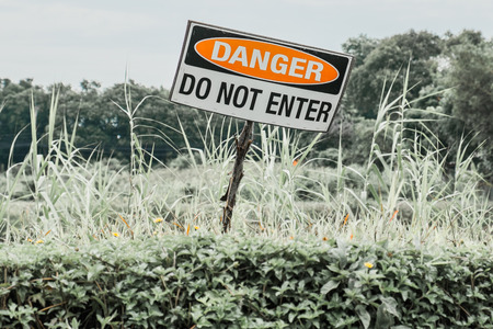 Old grungy warning sign showing danger