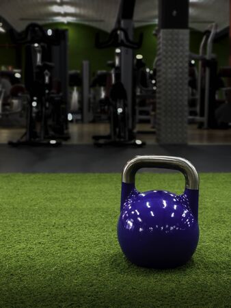 Kettlebell at a gym with static bikes on the background with copy spaceの写真素材