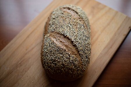 Multigrain homemade bread on a wooden cutting board