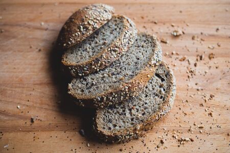 Sliced multigrain homemade bread on a wooden cutting board
