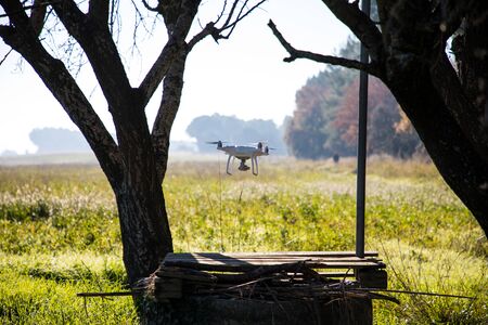 Drone over water well and under tree on sunny winter morning