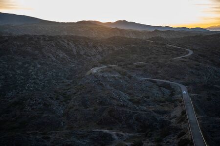 View of a mountain curved road with sunset sky in Cap de Creus, Catalunya