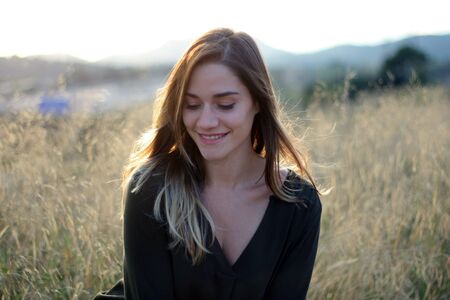 Beautiful women portrait in wheat field during sunset
