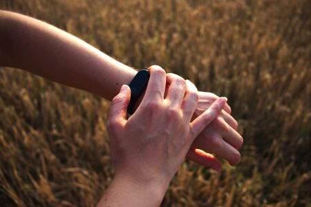 Women hand setting up an activity monitor wristbandの写真素材