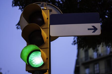 Traffic light on green with empty street sign for copy space