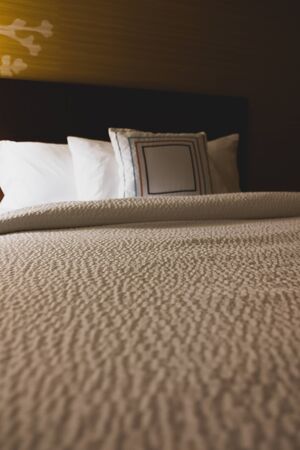 Empty hotel bed perspective view