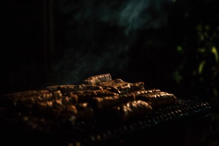 Closeup of barbeque with meat at night
