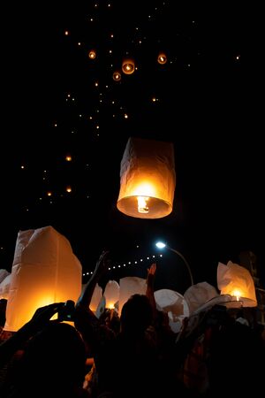 People releasing paper lanterns during Loi Krathong and Yi Peng festival