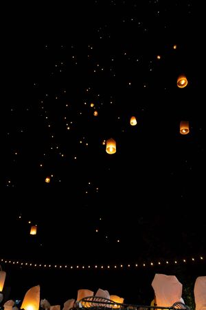 People releasing paper lanterns during Loi Krathong and Yi Peng festival