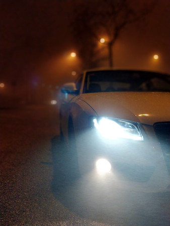 March 1st, 2018 - Terrassa, SPAIN - White car front shot at night with mistのeditorial素材