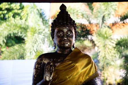 Close up view of an old golden buddha with nature in the backgroundのeditorial素材