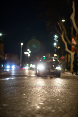 Blurred vehicle front view at night from street view low shotの写真素材