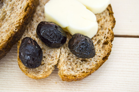 Bran besides bread and black olives, cheese, the most beautiful breakfast cheese and black olives.の写真素材