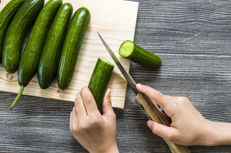 Cucumber pictures on the cutting board, cutting the cucumber with the knife,の写真素材