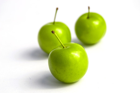 Sour plum pictures on white ground, wonderful sour plums, green plums pictures from the first fruits in summerの写真素材