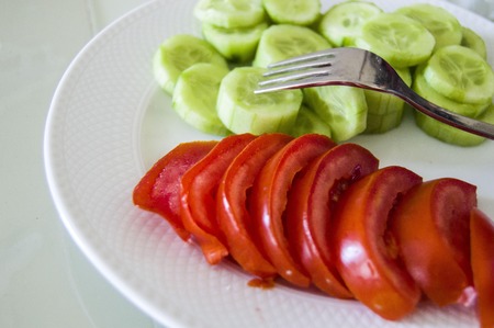 tomato and cucumber at breakfastの写真素材