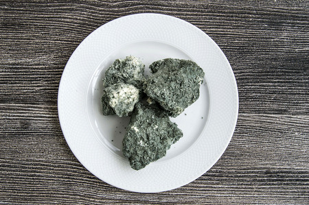 moldy cheese pieces in the plateの写真素材