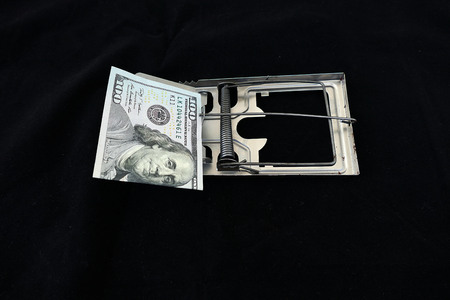 Metal mouse trap that has caught the 100 US dollars,