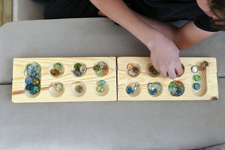 wooden mancala and stones,