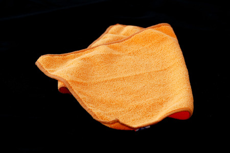 microfiber cleaning cloths in orange color, black back ground,の写真素材