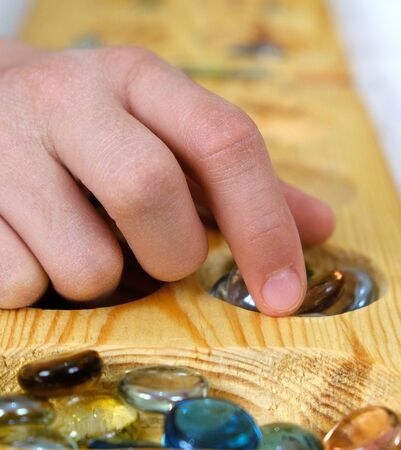 playing mancala at home, mancala intelligence game on carpet,