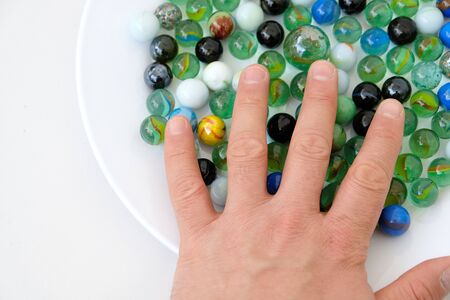 fun game for kids with colored glass marbles, glass balls,の写真素材