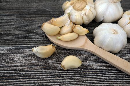 garlic grains on wooden background, close up,の写真素材