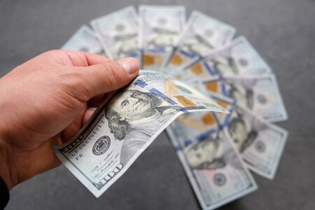 $100 dollars too much standing on a black background, world currency dollars,の写真素材