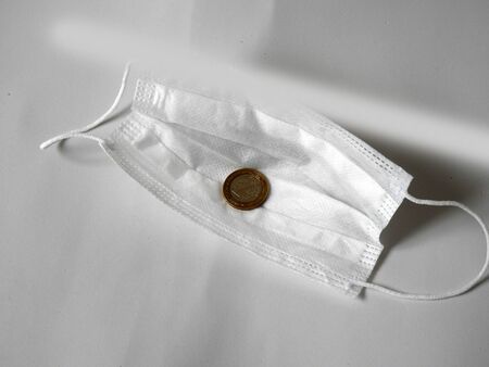 a protective mask for the covid-19 virus and 1 turkish lira,
