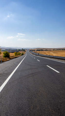 newly built asphalt road highway and vehicles long asphalt road,