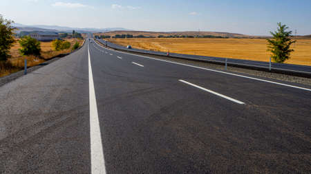newly built asphalt road highway and vehicles long asphalt road,