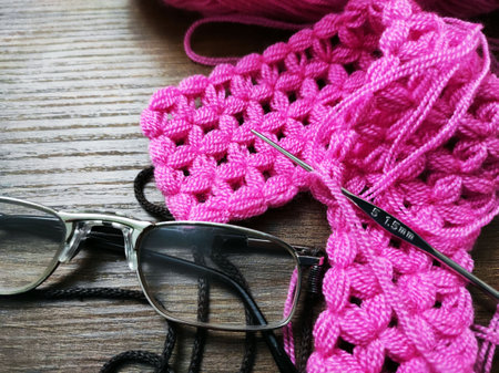 orlon thread and crochet and glasses stand side by side,